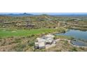 Expansive estate featuring a manicured golf course, private lake, and modern architecture at 15332 E Hidden Springs Trl, Fountain Hills, AZ 85268