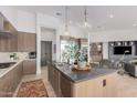 Sleek kitchen boasts an oversized center island, custom wood cabinetry, and stainless appliances at 15332 E Hidden Springs Trl, Fountain Hills, AZ 85268