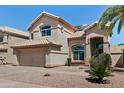 Two-story home featuring desert landscaping, a two-car garage, and a well-maintained yard at 162 W El Freda Rd, Tempe, AZ 85284