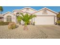 Charming single-story home boasts a well-maintained front yard with desert landscaping and a two-car garage at 18001 N 44Th Way, Phoenix, AZ 85032