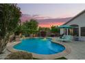 Enjoy a private backyard oasis featuring a sparkling pool, lush landscaping, and comfortable lounge chairs at 18001 N 44Th Way, Phoenix, AZ 85032