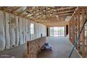 Spacious unfinished room with exposed framing and sliding glass doors to the exterior at 18271 W La Senda Dr, Surprise, AZ 85387