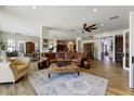 Spacious living room with wood floors, comfortable leather furniture, and a decorative rug at 20627 W Grandview Dr, Buckeye, AZ 85396