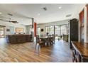 Open-concept living room featuring wood floors, dining area, large windows, and plenty of natural light at 20627 W Grandview Dr, Buckeye, AZ 85396