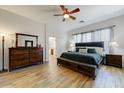 Cozy bedroom with ample natural light, wood-look floors, and a comfortable king-sized bed at 20627 W Grandview Dr, Buckeye, AZ 85396