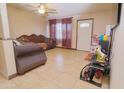 Open living room featuring tile floors, neutral walls, and a white front door for an inviting space at 2305 E Southern Ave, Phoenix, AZ 85040