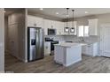 Spacious kitchen with stainless steel appliances, white cabinets, granite countertops, and an island at 26308 W Camino Del Sol --, Casa Grande, AZ 85193