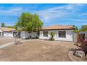 Lovely home with a tile roof and landscaping features, showcasing curb appeal at 2640 E Mallory St, Mesa, AZ 85213