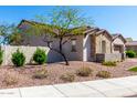 Attractive two-story home with desert landscaping, manicured bushes, and an inviting, cozy feel at 30857 N 128Th Dr, Peoria, AZ 85383