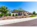 Attractive two-story home with desert landscaping, manicured bushes, and a cozy, inviting feel at 30857 N 128Th Dr, Peoria, AZ 85383