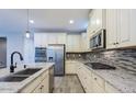 Beautiful kitchen featuring granite countertops, stainless steel appliances, and ample cabinet space at 3386 E Strawberry Dr, Gilbert, AZ 85298