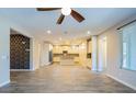 Spacious living room offering a view of the open-concept kitchen with pendant lighting at 3386 E Strawberry Dr, Gilbert, AZ 85298