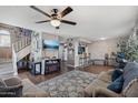 Open-concept living area with fireplace, television, breakfast bar, and staircase for flexible living at 3732 W Bluefield Ave, Glendale, AZ 85308