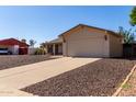 Lovely one story home featuring an attached two-car garage and drought tolerant rock landscaping at 3828 W Crocus Dr, Phoenix, AZ 85053