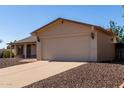 Close-up shot of an attached, two-car garage and charming beige exterior of a well-maintained home at 3828 W Crocus Dr, Phoenix, AZ 85053