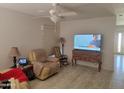 Spacious living room with a ceiling fan, and view of a wall-mounted television at 3828 W Crocus Dr, Phoenix, AZ 85053