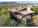 Stunning aerial view of a unique modern home with a pool, lush landscaping, and mountain views at 39541 N 107Th Way, Scottsdale, AZ 85262