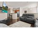 Open-concept space flows from the kitchen to the cozy living area with a modern TV at 420 W First St # 217, Tempe, AZ 85281