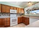 Traditional kitchen with tile floors, warm wood cabinets, stainless steel appliances, and lots of natural light at 5337 W Diana Ave, Glendale, AZ 85302