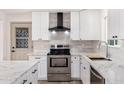 Newly remodeled kitchen featuring white cabinetry, stainless steel appliances, and stylish countertops at 5452 E University Dr, Mesa, AZ 85205