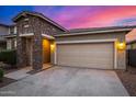 Home with a two-car garage and stone accents on the front of the building at 5752 N 109Th Ave, Phoenix, AZ 85037