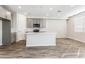 Charming kitchen with gray cabinets, stainless appliances, and island at 5828 E Covey Ln, Phoenix, AZ 85054