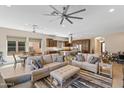 Open concept living space with sofas, and access to a kitchen with a large island at 644 E Las Puertas Ln, Queen Creek, AZ 85140