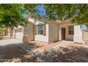 Charming home with neat landscaping, a brick-lined walkway, and inviting, warm-toned exterior at 9518 W Hazelwood St, Phoenix, AZ 85037