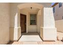 Inviting front porch features a decorative security door and charming brick-lined flooring at 9518 W Hazelwood St, Phoenix, AZ 85037