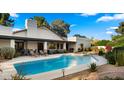 Backyard with pool features a large patio area and a built-in barbecue grill, great for entertaining at 10025 E Larkspur Dr, Scottsdale, AZ 85260