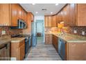 Beautiful kitchen featuring granite countertops, stainless steel appliances, and mosaic tile backsplash at 102 E Angela Dr, Phoenix, AZ 85022