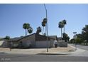 Attractive single-level home showcasing a brick front, attached garage, lush landscaping, and stately palm trees, located on a corner lot at 12601 N 34Th St, Phoenix, AZ 85032