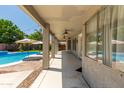 Spacious covered patio with ceiling fans overlooking the pool and yard at 13323 W Rancho Dr, Litchfield Park, AZ 85340