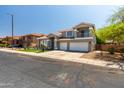 This two-story home features a balcony and a spacious three-car garage at 13323 W Rancho Dr, Litchfield Park, AZ 85340