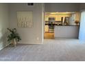 Spacious living room flowing into the kitchen with stainless steel appliances at 1432 W Emerald Ave # 686, Mesa, AZ 85202