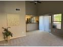 Open living room with vaulted ceilings and access to kitchen with stainless appliances at 1432 W Emerald Ave # 686, Mesa, AZ 85202