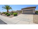 Well-maintained house with a two-car garage, desert landscaping, and a clean sidewalk at 15134 W Waterford Dr, Surprise, AZ 85374