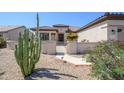 Inviting home exterior with manicured landscaping and a gated walkway at 15134 W Waterford Dr, Surprise, AZ 85374