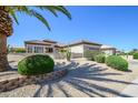 Beautiful front yard with desert landscaping, lush greenery, and a well-maintained garden at 15134 W Waterford Dr, Surprise, AZ 85374
