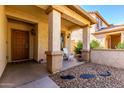 Inviting front porch with decorative columns and desert landscaping at 152 N 194Th Ln, Buckeye, AZ 85326