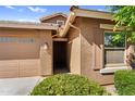 Close-up view of the front entrance, showing house number and decorative shrubbery at 16396 W Questa Dr, Surprise, AZ 85387