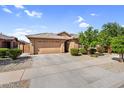 Beautiful home with a desert-landscaped front yard, a two-car garage, and a welcoming walkway at 16396 W Questa Dr, Surprise, AZ 85387