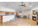 Bright and airy living space with wood-look floors, vaulted ceilings, and a fireplace, perfect for entertaining at 16924 W Stevenage St, Surprise, AZ 85374