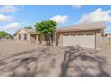 Side view of a single-story home with a large driveway and two-car garage at 18629 N 10Th Ave, Phoenix, AZ 85027