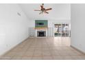 A spacious living room with tile floors, a fireplace, and sliding glass doors to backyard at 18629 N 10Th Ave, Phoenix, AZ 85027