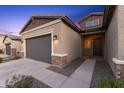 Inviting single-story home with a two-car garage, desert landscaping, and a cozy entrance at 19231 W Missouri Ave, Litchfield Park, AZ 85340