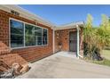 Inviting front entrance with brick accents, security door and desert landscaping at 1945 E Solano Dr, Phoenix, AZ 85016