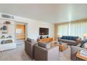 Bright and spacious living room featuring plush carpeting and built-in shelving at 1945 E Solano Dr, Phoenix, AZ 85016