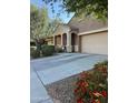 Charming single-story home with well-manicured landscaping, covered porch, and two car garage at 20230 N Jill Ave, Maricopa, AZ 85138