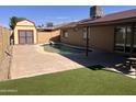 Private backyard with a refreshing swimming pool, artificial turf, and a storage shed at 2130 W Devonshire St, Mesa, AZ 85201